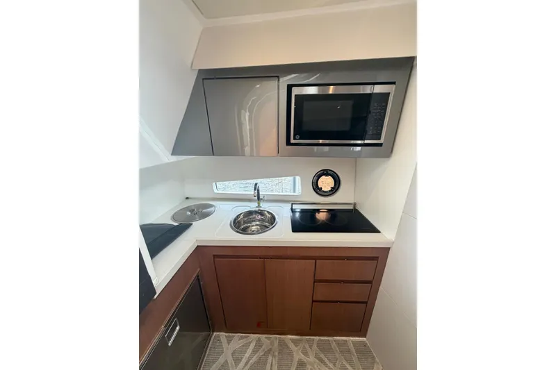 Slide: The Image of Compact kitchen in 2022 Schaefer 400 Sport yacht with modern appliances and sleek design. - 25