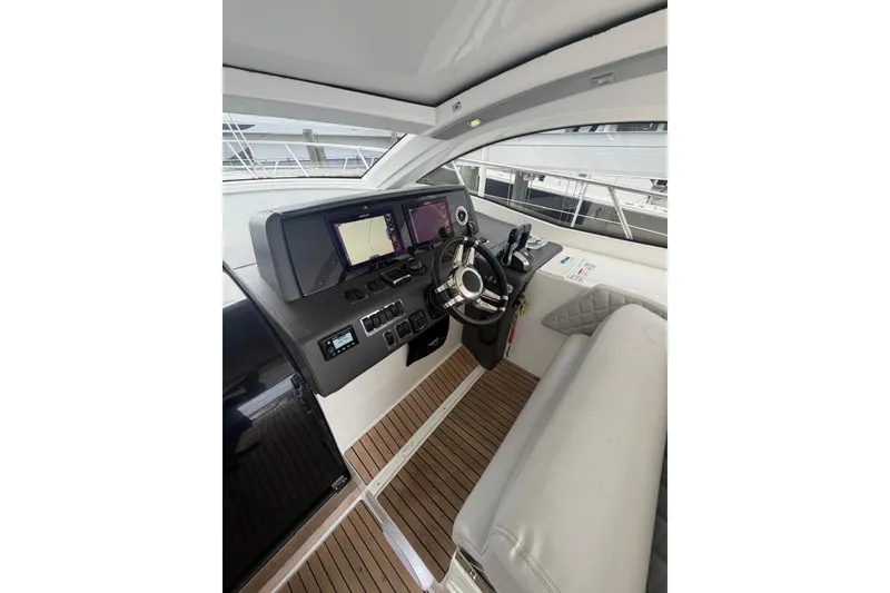 Slide: The Image of Interior of 2022 Schaefer 400 Sport yacht with modern helm and navigation systems. - 28