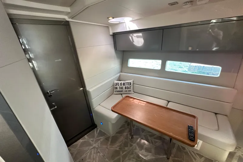 Slide: The Image of 2022 Schaefer 400 Sport interior with seating, table, and decorative sign. - 5