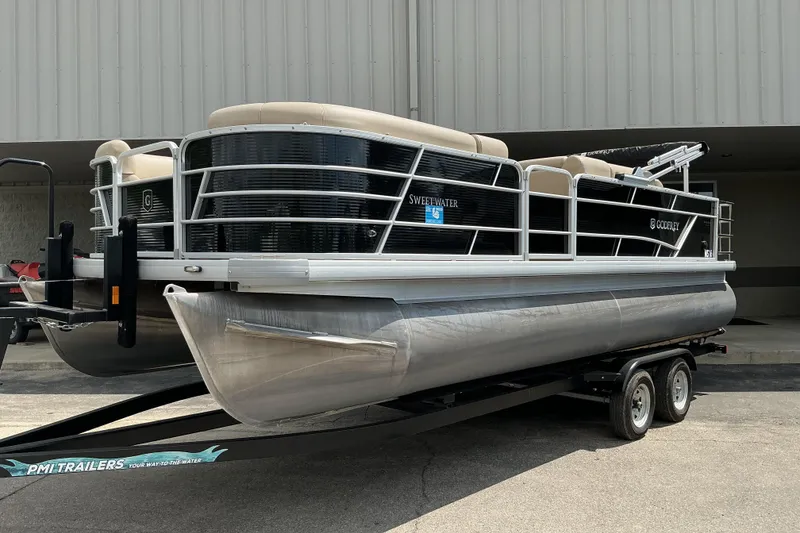 The Image of 2023 Godfrey Sweetwater 2286 SFL pontoon boat on trailer, parked outdoors. - 1