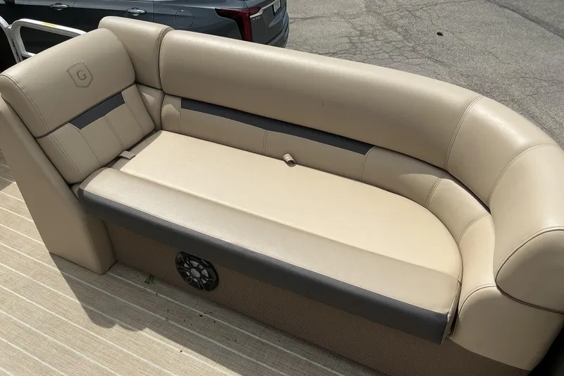 Slide: The Image of 2023 Godfrey Sweetwater 2286 SFL boat seating, beige upholstery, outdoor setting. - 14