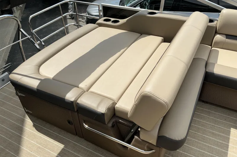 Slide: The Image of 2023 Godfrey Sweetwater 2286 SFL boat with beige cushioned seating and cup holders. - 15