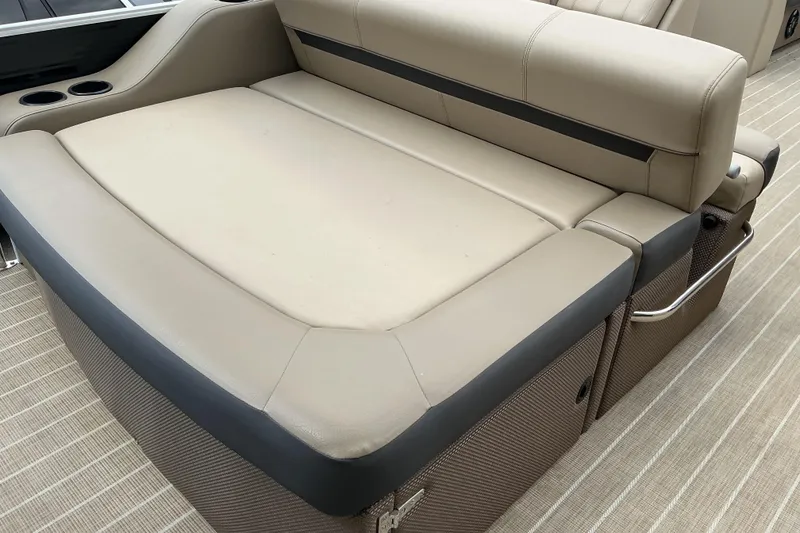Slide: The Image of 2023 Godfrey Sweetwater 2286 SFL boat interior with beige seating and cup holders. - 16