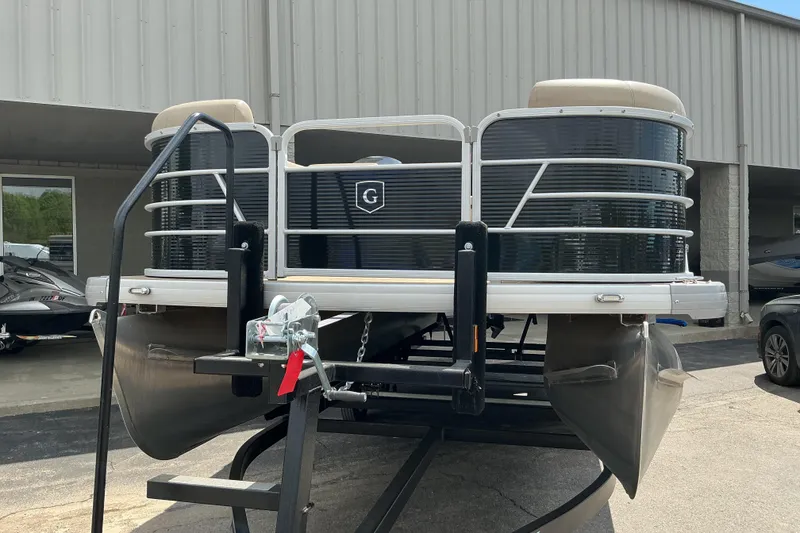 Slide: The Image of 2023 Godfrey Sweetwater 2286 SFL pontoon boat on trailer, parked outside a building. - 3