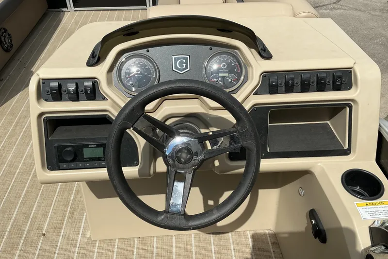 Slide: The Image of 2023 Godfrey Sweetwater 2286 SFL boat dashboard with steering wheel and control panel. - 8