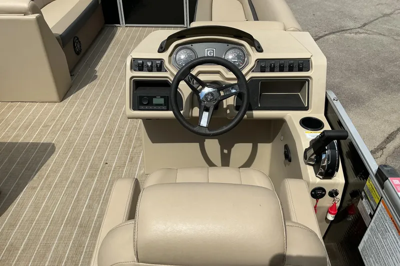 Slide: The Image of 2023 Godfrey Sweetwater 2286 SFL boat dashboard with steering wheel and controls. - 9