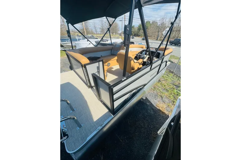 Slide: The Image of 2026 Crest Conquest SE 180 Cruise pontoon boat with tan seating and canopy. - 2