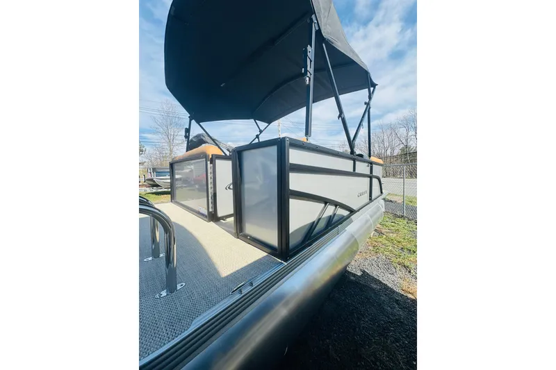Slide: The Image of 2026 Crest Conquest SE 180 Cruise pontoon boat with canopy, side view. - 4