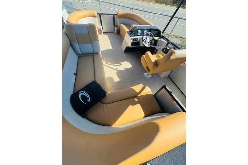 Slide: The Image of 2026 Crest Conquest SE 180 Cruise interior with tan seating and steering console. - 7