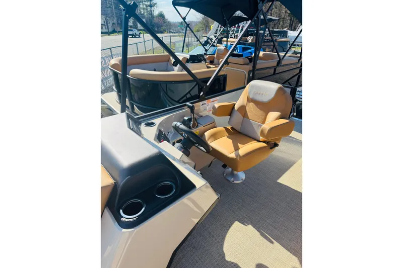Slide: The Image of 2026 Crest Conquest SE 180 Cruise boat interior with tan captain's chair and steering console. - 9