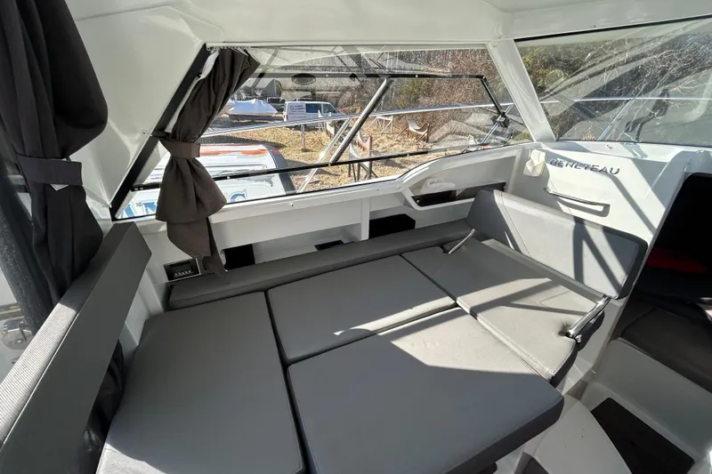 Slide: The Image of Interior of 2021 Beneteau Antares 8 boat with convertible seating and large windows. - 10