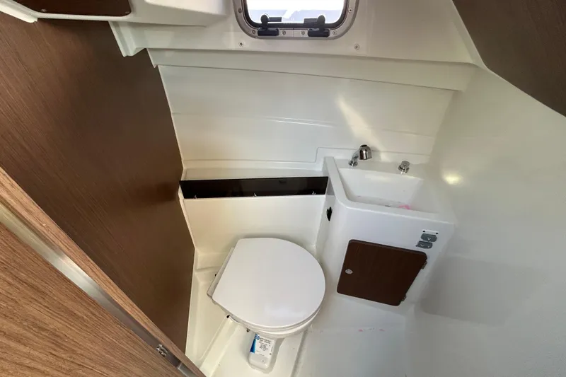 Slide: The Image of Compact bathroom in 2021 Beneteau Antares 8 boat with toilet and sink. - 14