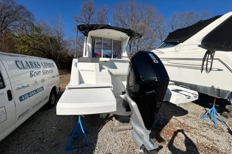 Slide: The Image of 2021 Beneteau Antares 8 boat with outboard motor, parked near service van. - 2