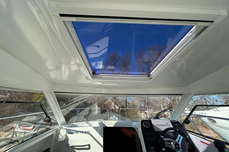 Slide: The Image of Interior view of 2021 Beneteau Antares 8 boat with sunroof and Garmin navigation system. - 4