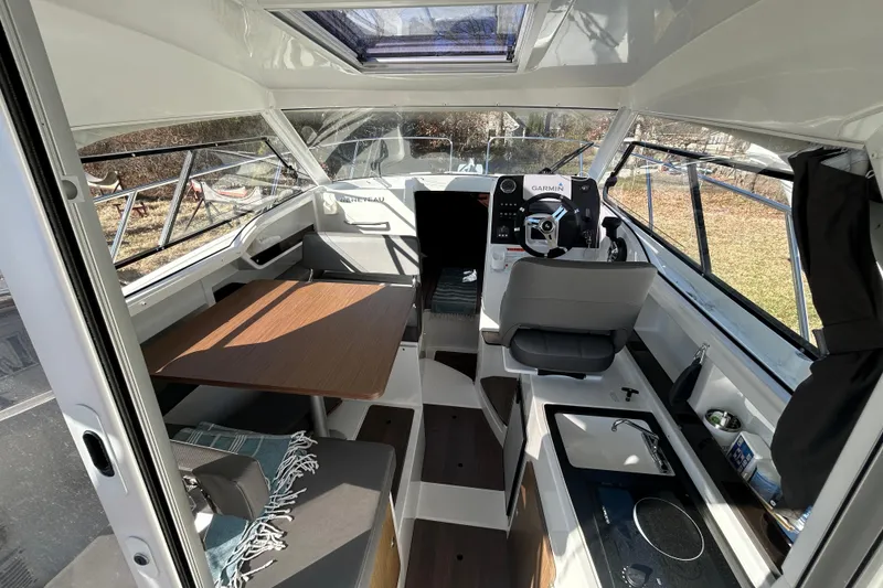 Slide: The Image of Interior of 2021 Beneteau Antares 8 boat with seating, table, and helm. - 7