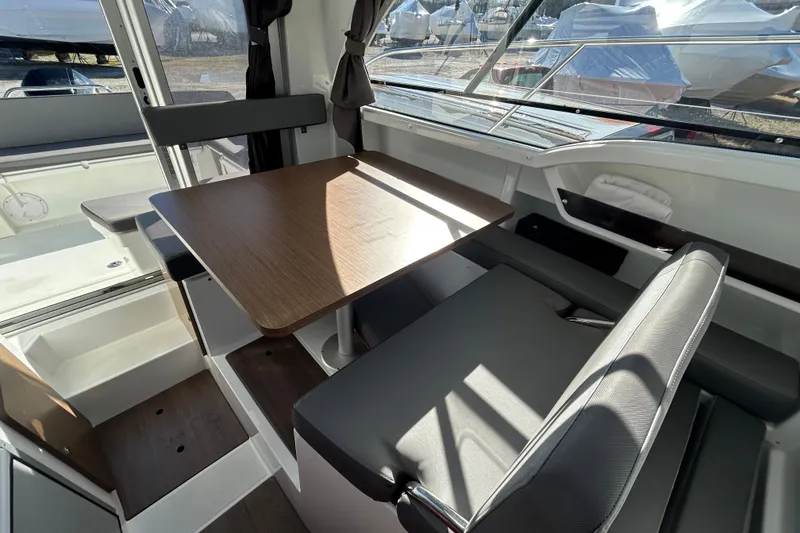 Slide: The Image of Interior of 2021 Beneteau Antares 8, featuring a modern dining area with wooden table. - 9