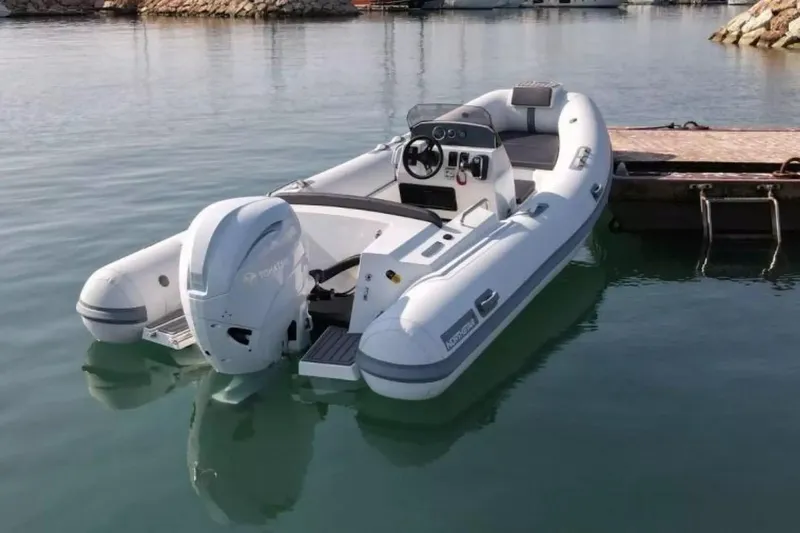 Slide: The Image of 2026 Northstar Axis 5.3 boat with Yamaha 115HP engine docked in calm waters. - 6