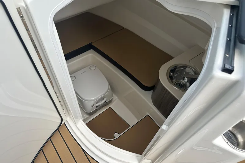 Slide: The Image of Interior of 2026 Sea Ray SDX 250 boat featuring compact bathroom amenities. - 10