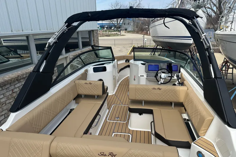 Slide: The Image of 2026 Sea Ray SDX 250 boat interior with tan seating and modern dashboard. - 14