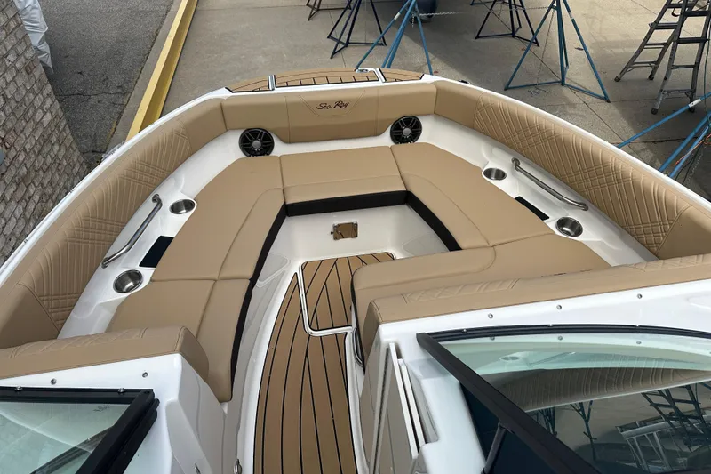 Slide: The Image of 2026 Sea Ray SDX 250 boat interior with tan seating and wood accents. - 3