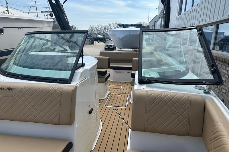Slide: The Image of 2026 Sea Ray SDX 250 boat interior with tan seating and open windshield. - 4