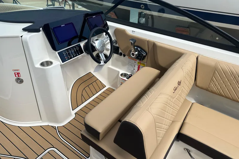 Slide: The Image of 2026 Sea Ray SDX 250 boat interior with beige seating and modern dashboard. - 6