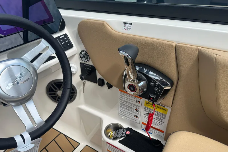 Slide: The Image of 2026 Sea Ray SDX 250 boat cockpit with steering wheel and control panel. - 8