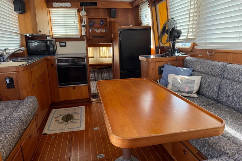 Slide: The Image of Interior of 1997 Sabreline 36 Express yacht with kitchen and seating area. - 10