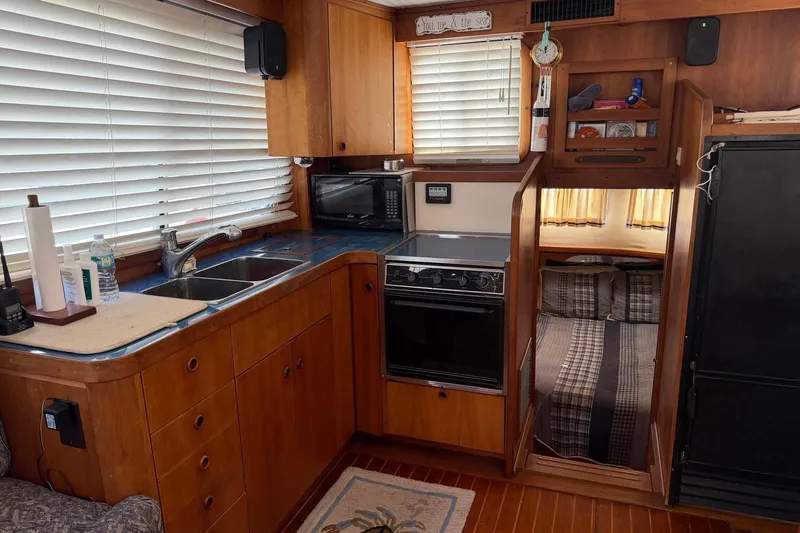 Slide: The Image of Interior of a 1997 Sabreline 36 Express boat with kitchen and cozy sleeping area. - 14