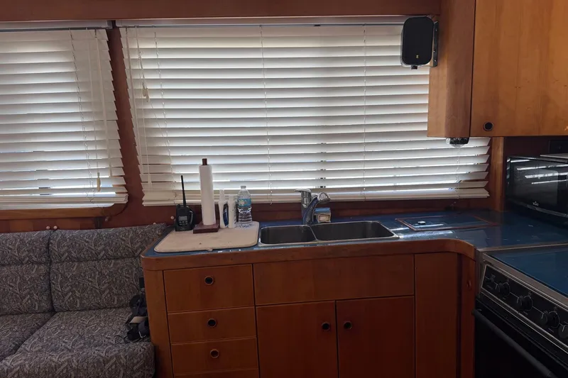 Slide: The Image of Interior of 1997 Sabreline 36 Express yacht with kitchen and seating area. - 15