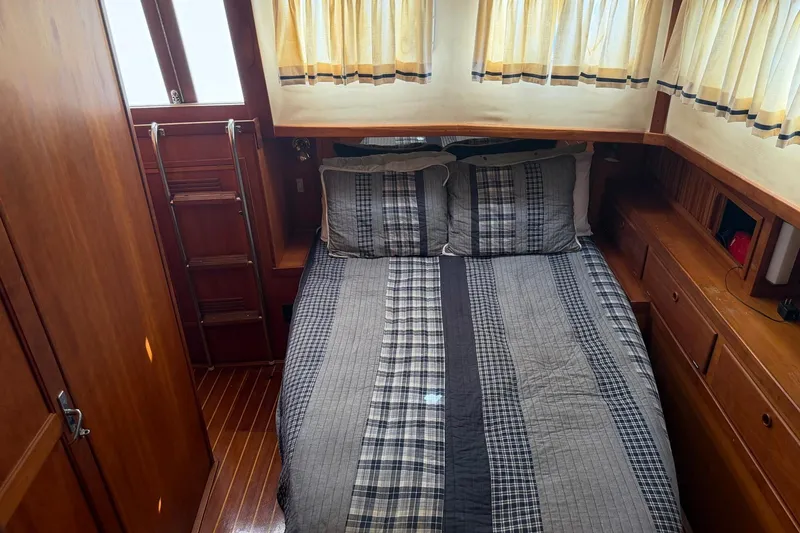 Slide: The Image of Cozy cabin interior of 1997 Sabreline 36 Express with plaid bedding and wooden furnishings. - 16