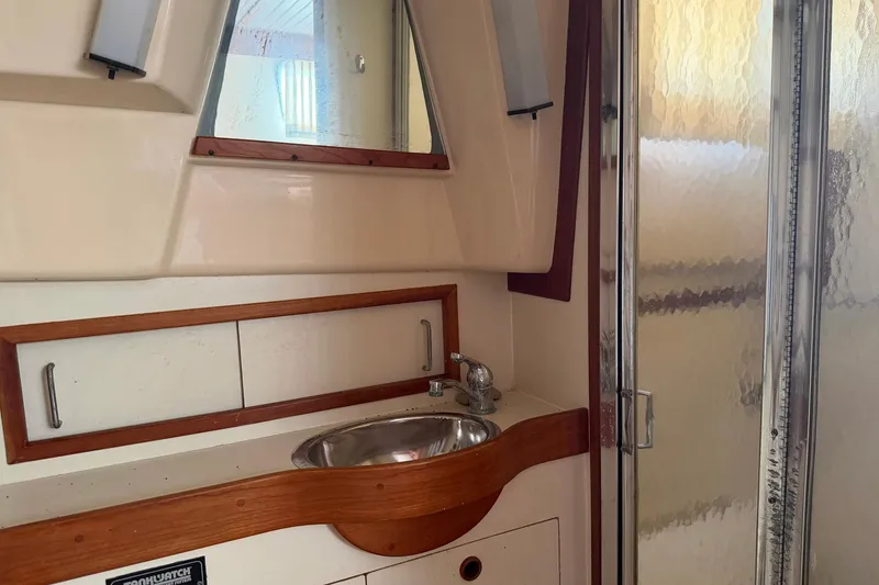 Slide: The Image of 1997 Sabreline 36 Express yacht bathroom with sink, mirror, and shower. - 17
