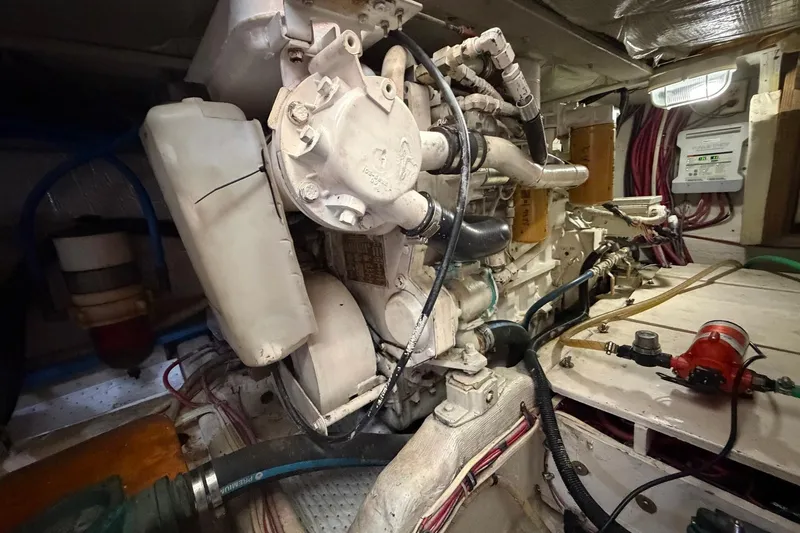 Slide: The Image of Engine room of a 1997 Sabreline 36 Express boat, showcasing mechanical components and wiring. - 19