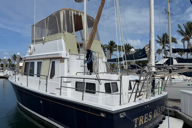 Slide: The Image of 1997 Sabreline 36 Express yacht docked at marina, featuring a spacious cabin and sleek design. - 2