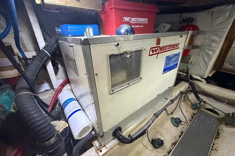Slide: The Image of Engine room of 1997 Sabreline 36 Express with Westerbeke generator and maintenance supplies. - 20