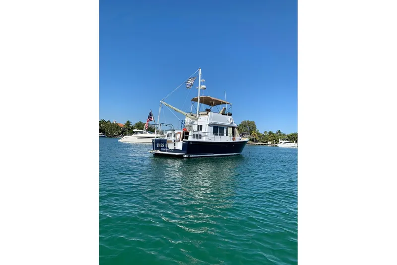 Slide: The Image of 1997 Sabreline 36 Express boat on clear blue water under sunny sky. - 22