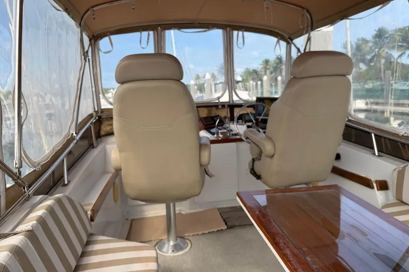 Slide: The Image of Interior of 1997 Sabreline 36 Express boat with helm and seating area. - 3