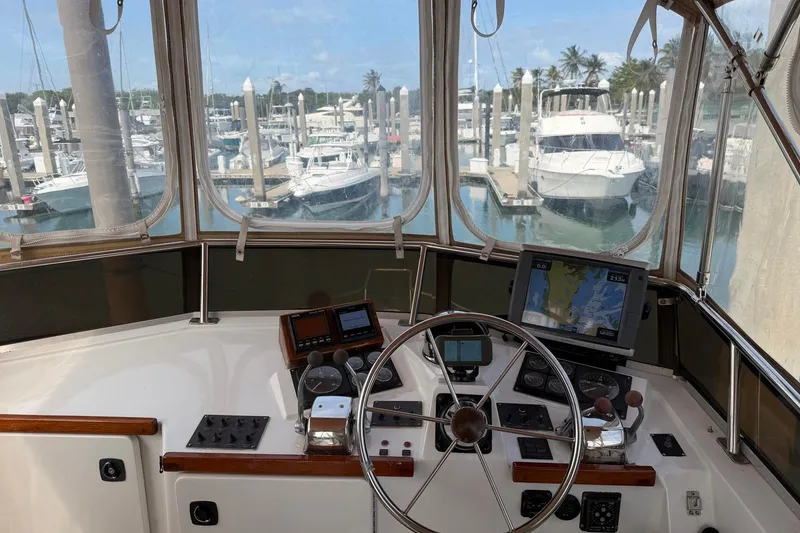 Slide: The Image of Cockpit view of 1997 Sabreline 36 Express yacht at marina, featuring navigation equipment. - 4
