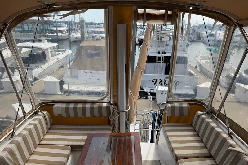Slide: The Image of 1997 Sabreline 36 Express yacht interior with striped seating at marina. - 5