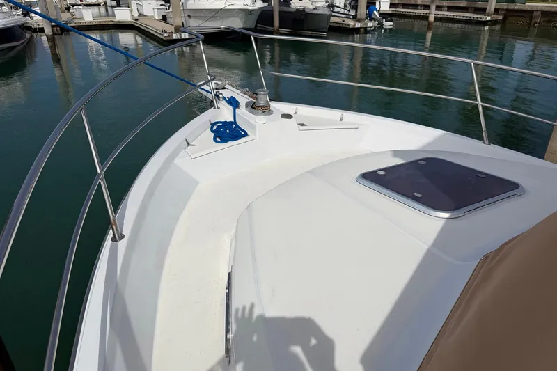 Slide: The Image of 1997 Sabreline 36 Express boat deck with railing and hatch in marina. - 6