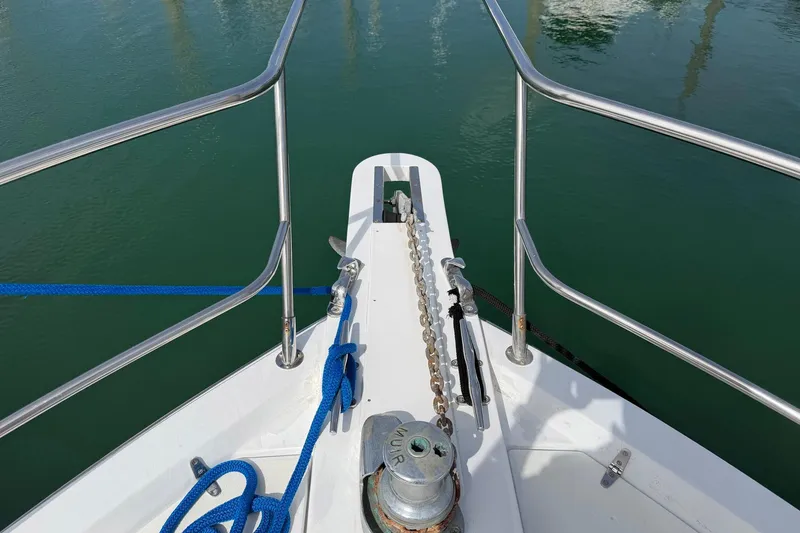 Slide: The Image of Bow of 1997 Sabreline 36 Express with anchor chain and blue ropes. - 7