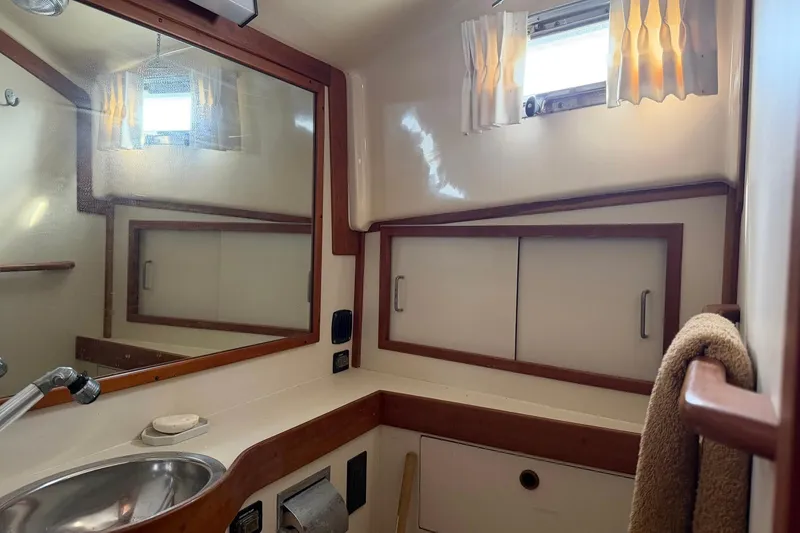 Slide: The Image of Bathroom interior of 1997 Sabreline 36 Express yacht with mirror and sink. - 9