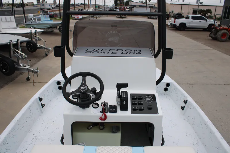 Slide: The Image of 2026 Freedom Boats 19 PATRIOT dashboard with steering wheel and controls. - 10