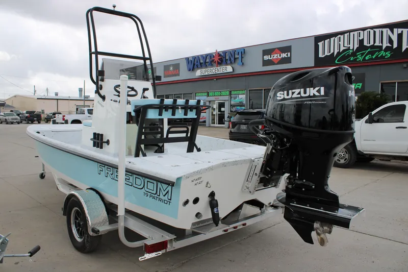 Slide: The Image of 2026 Freedom Boats 19 PATRIOT with Suzuki engine at dealership. - 11