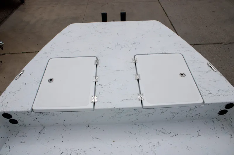 Slide: The Image of 2026 Freedom Boats 19 PATRIOT deck with dual storage hatches, featuring a sleek design. - 13