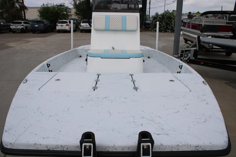 Slide: The Image of 2026 Freedom Boats 19 PATRIOT with sleek design and spacious deck in a parking area. - 19