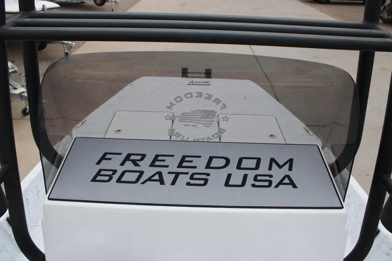Slide: The Image of Freedom Boats 19 PATRIOT 2026 model with "FREEDOM BOATS USA" branding on console. - 2