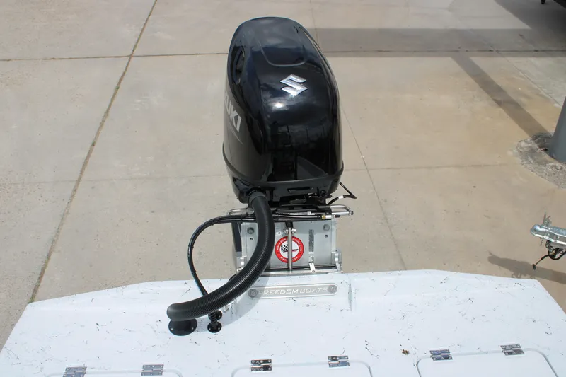 Slide: The Image of Outboard motor on 2026 Freedom Boats 19 PATRIOT, parked on concrete surface. - 7
