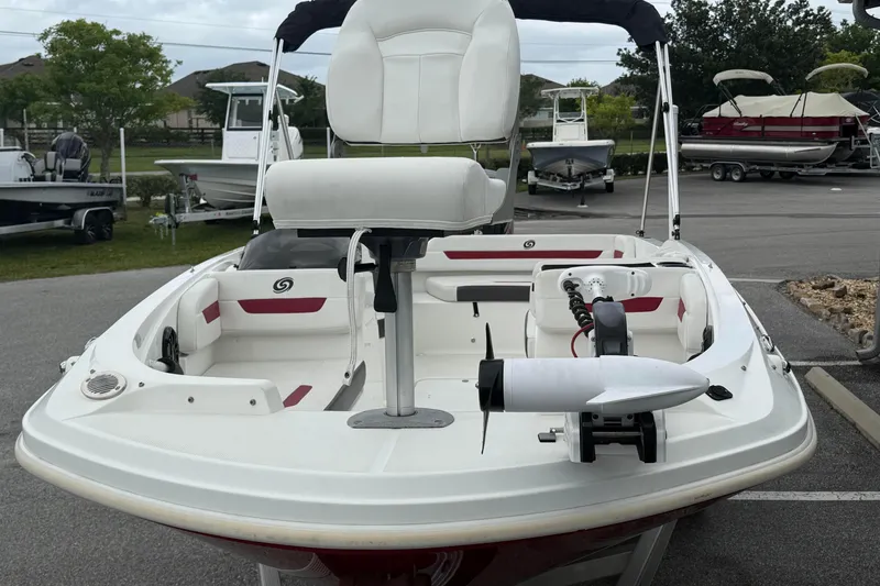 Slide: The Image of 2023 Hurricane SunDeck Sport 185 OB boat with seating and motor, parked outdoors. - 10