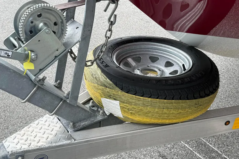 Slide: The Image of Trailer wheel and winch mechanism on 2023 Hurricane SunDeck Sport 185 OB boat trailer. - 11